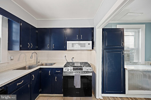 kitchen featuring sink, backsplash, blue cabinets, and stainless steel gas stove