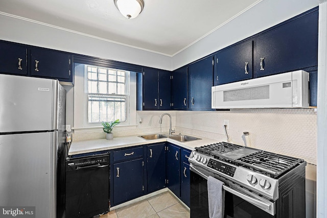 kitchen featuring appliances with stainless steel finishes, sink, light tile patterned floors, blue cabinets, and decorative backsplash