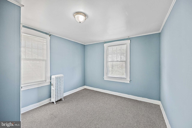 carpeted empty room featuring radiator heating unit and ornamental molding