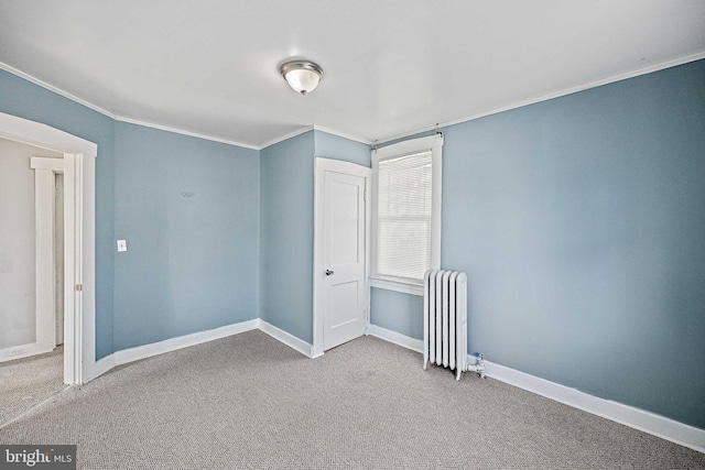 unfurnished bedroom with radiator heating unit, ornamental molding, and carpet flooring