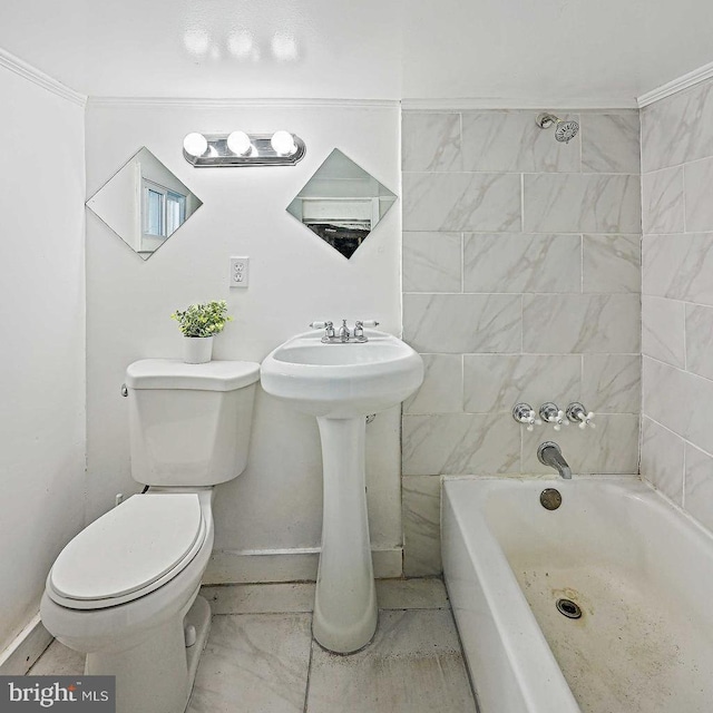 bathroom with toilet, ornamental molding, and a bathing tub