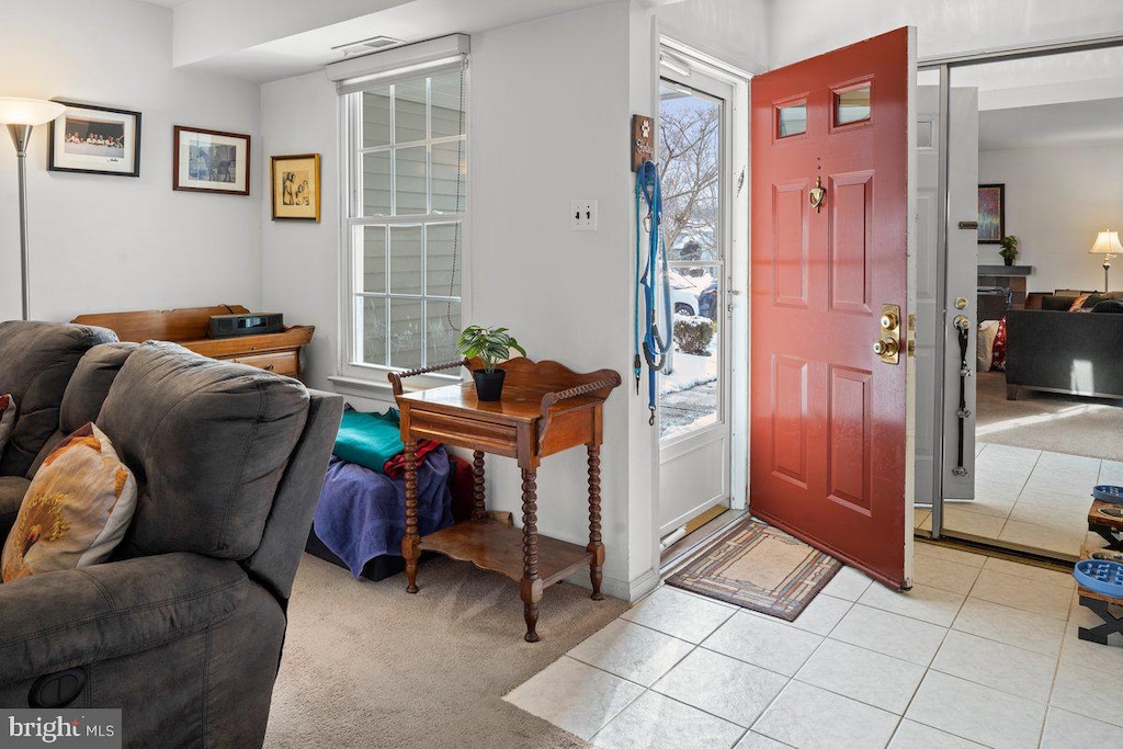 foyer featuring light tile patterned floors