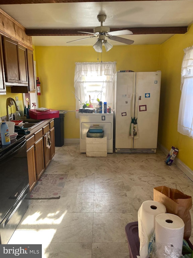 kitchen with white fridge, ceiling fan, sink, range, and beamed ceiling