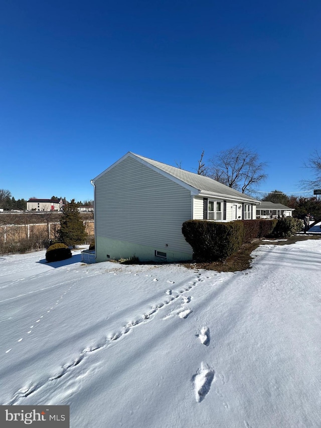 view of snowy exterior featuring crawl space