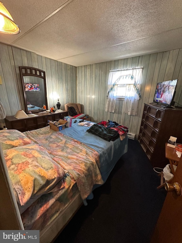 bedroom featuring carpet and a textured ceiling