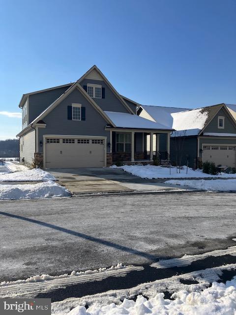 view of front facade featuring a porch and a garage