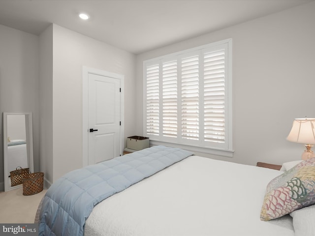 carpeted bedroom featuring multiple windows