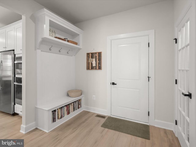 mudroom with light hardwood / wood-style flooring