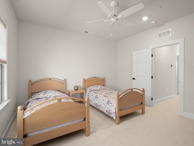 bedroom with ceiling fan and light colored carpet