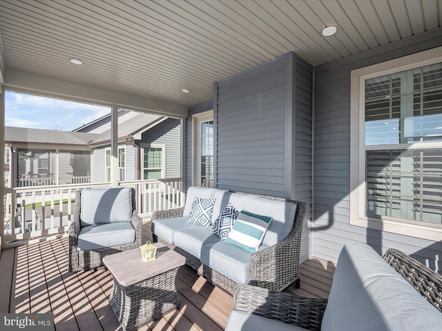 wooden terrace with an outdoor hangout area