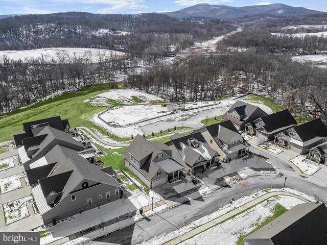 snowy aerial view featuring a mountain view