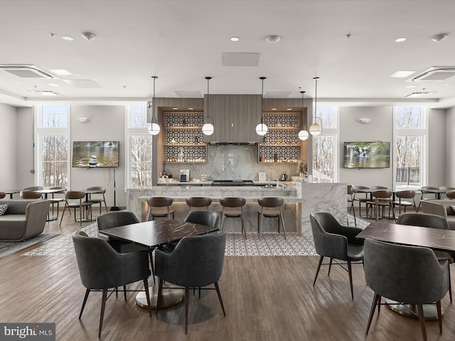 dining area with dark hardwood / wood-style flooring and indoor bar