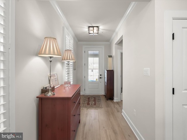 doorway to outside with ornamental molding and light hardwood / wood-style flooring