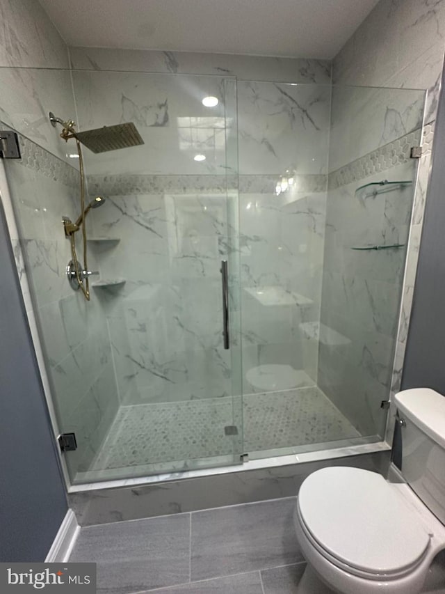 bathroom with an enclosed shower and toilet