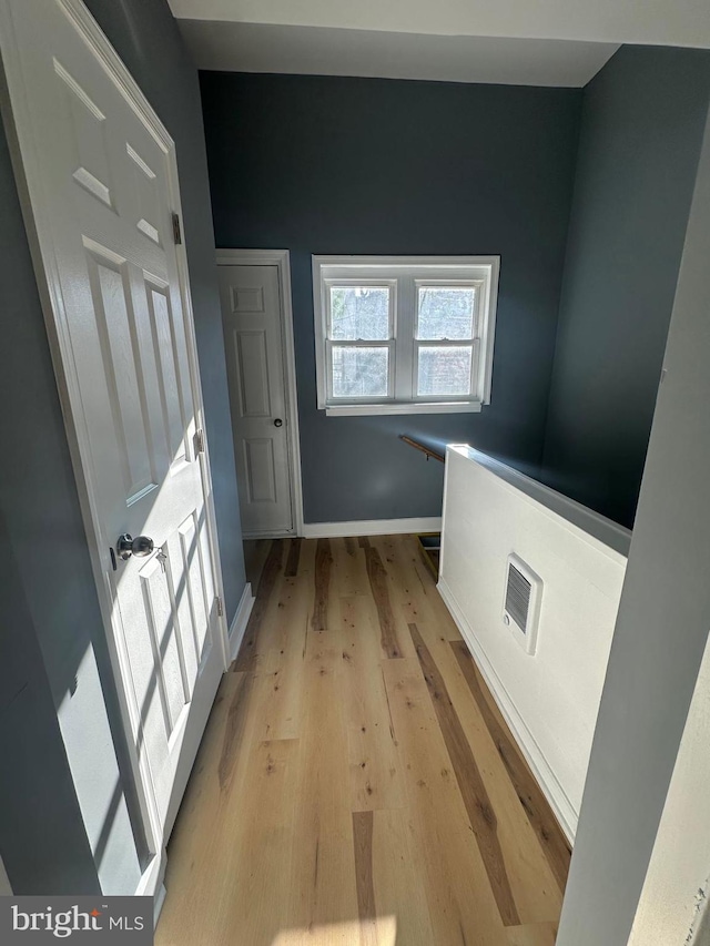 corridor with light hardwood / wood-style floors