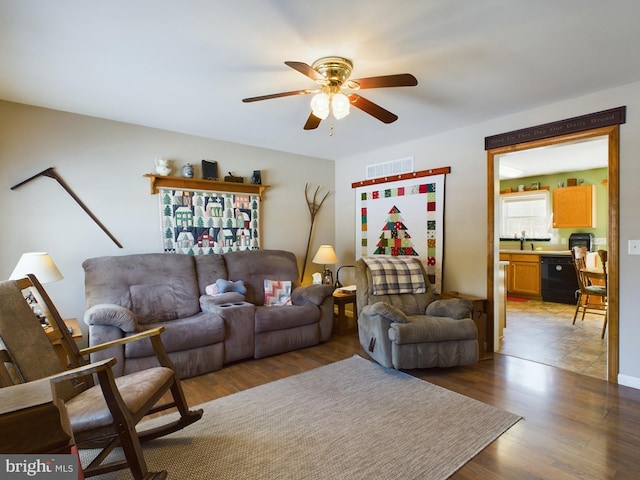 living room with ceiling fan, sink, and dark hardwood / wood-style floors