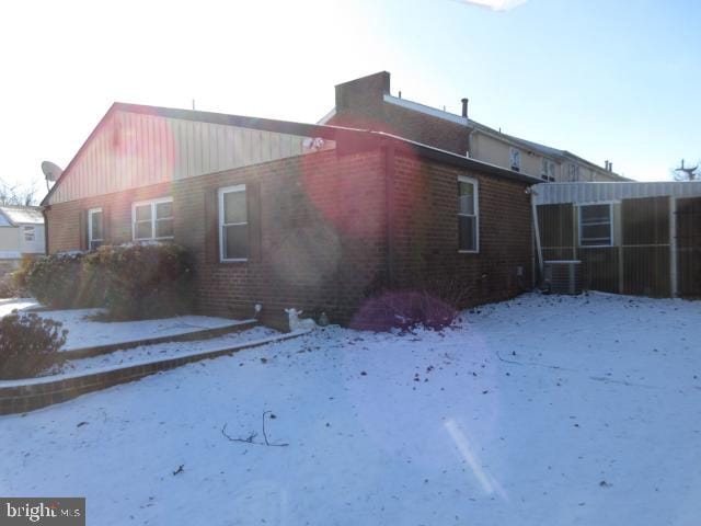 view of snow covered exterior featuring central air condition unit