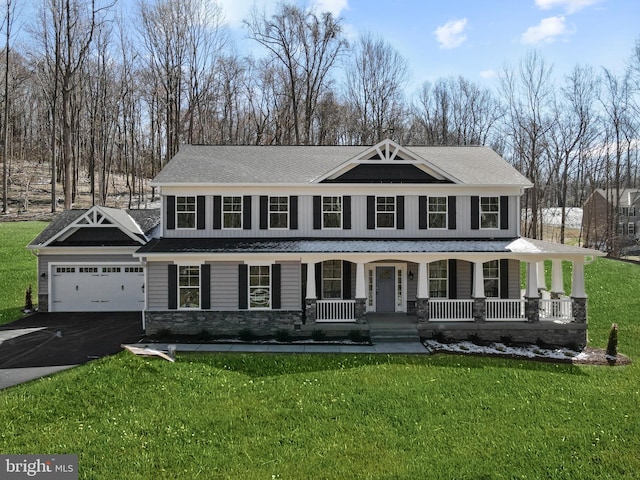 view of front facade featuring a front lawn, a porch, and a garage