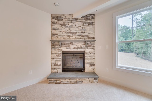 details with carpet floors, beamed ceiling, and a fireplace