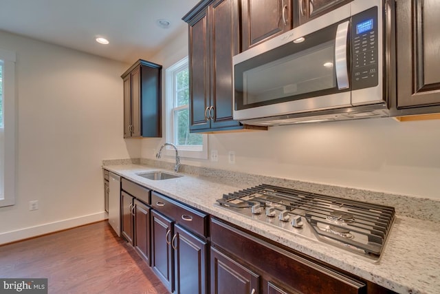 kitchen with sink, dark brown cabinetry, and stainless steel appliances