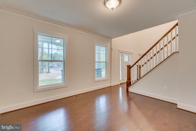 interior space featuring hardwood / wood-style flooring and crown molding