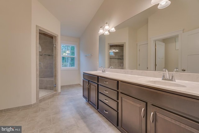 bathroom with vanity and a shower with door