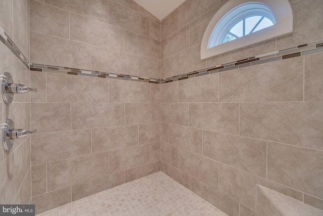 bathroom with a tile shower