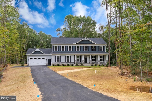 colonial-style house with a porch and a garage