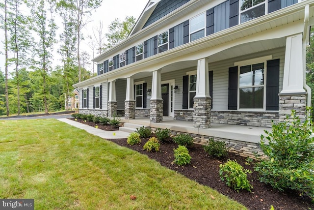 craftsman-style house with covered porch and a front yard