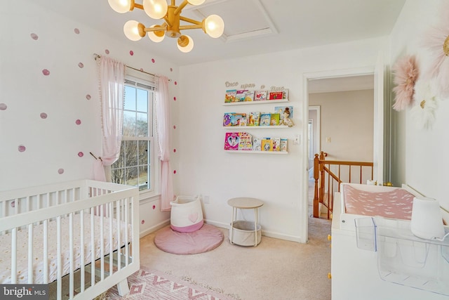 carpeted bedroom with a nursery area and a notable chandelier