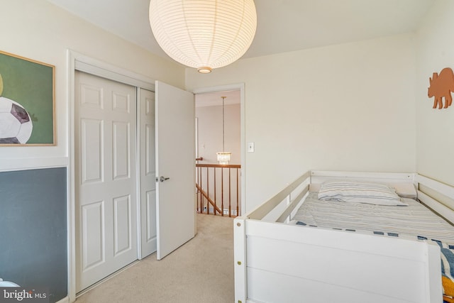 carpeted bedroom featuring a closet