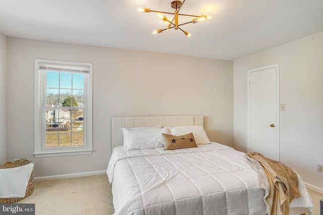 carpeted bedroom with a chandelier