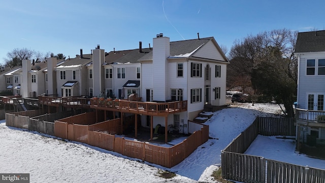 view of snow covered back of property