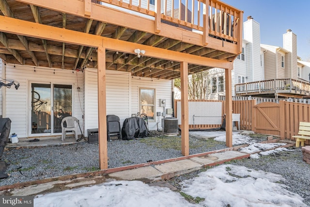 snow covered patio featuring central air condition unit