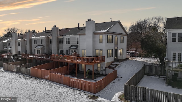 view of snow covered rear of property