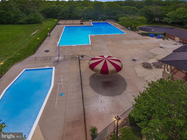 view of swimming pool featuring a patio area