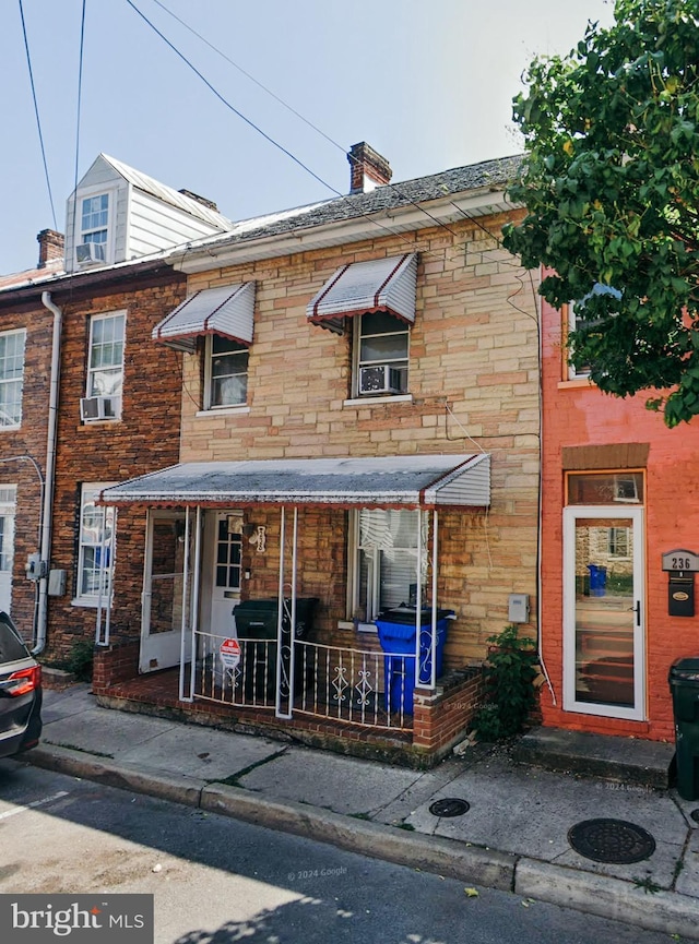 multi unit property featuring covered porch and cooling unit