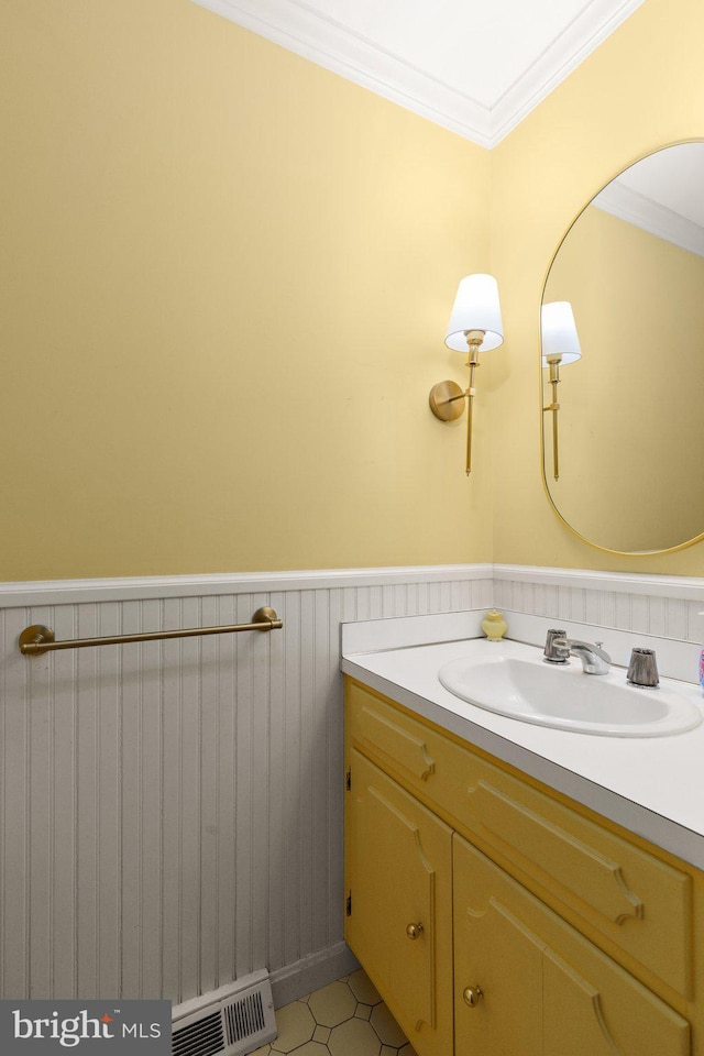 bathroom featuring tile patterned floors, vanity, and ornamental molding