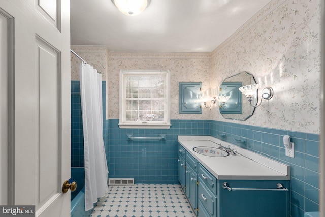 bathroom featuring tile walls, vanity, ornamental molding, and a shower with shower curtain