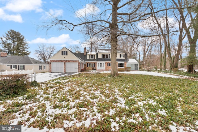 view of front of house featuring a garage and a lawn