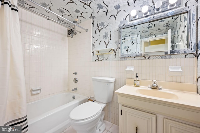 full bathroom featuring toilet, shower / tub combo, tile walls, vanity, and tile patterned flooring