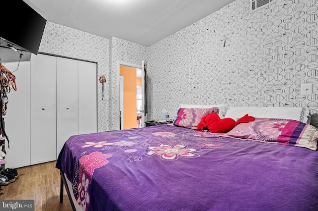 bedroom with a closet and wood-type flooring