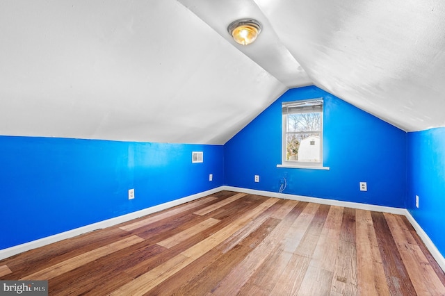 bonus room with vaulted ceiling and hardwood / wood-style floors