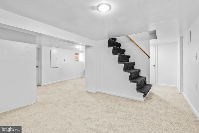 basement featuring light colored carpet