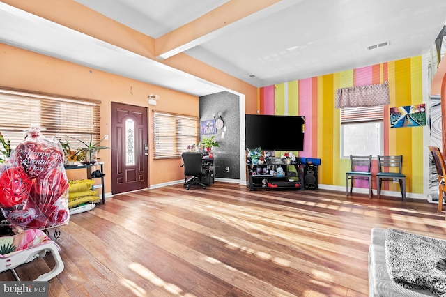 recreation room featuring hardwood / wood-style floors, plenty of natural light, and beamed ceiling