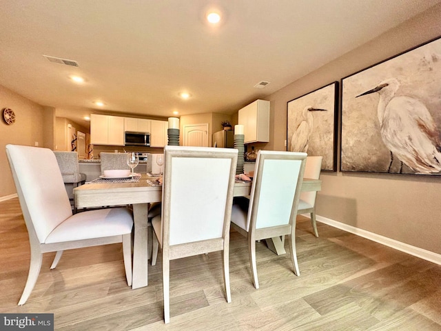 dining room with light wood-type flooring