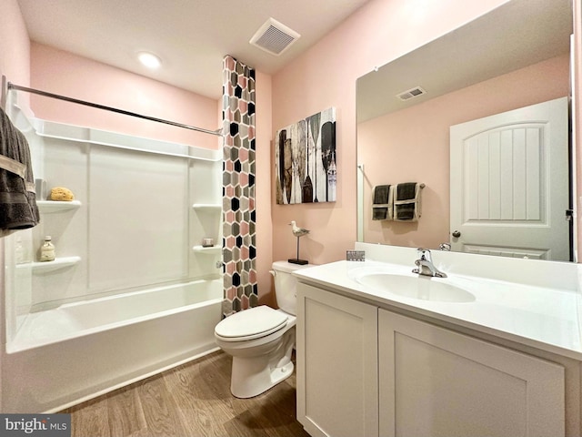 full bathroom featuring toilet, shower / bath combo with shower curtain, vanity, and hardwood / wood-style floors