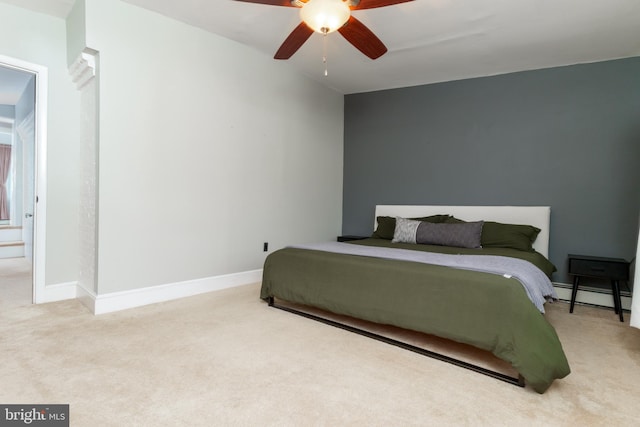 carpeted bedroom featuring ceiling fan and a baseboard radiator