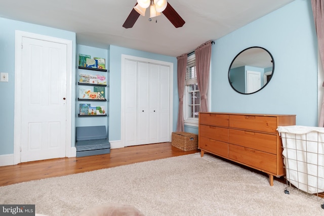 bedroom featuring ceiling fan, hardwood / wood-style flooring, and a closet