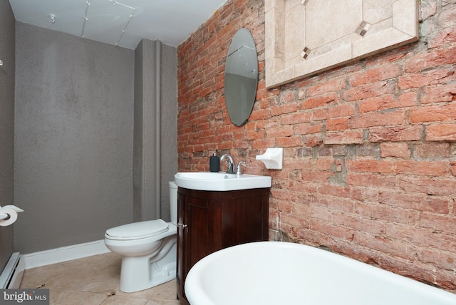 bathroom featuring brick wall, a baseboard heating unit, vanity, and toilet